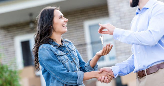 Woman getting the keys to an airbnb